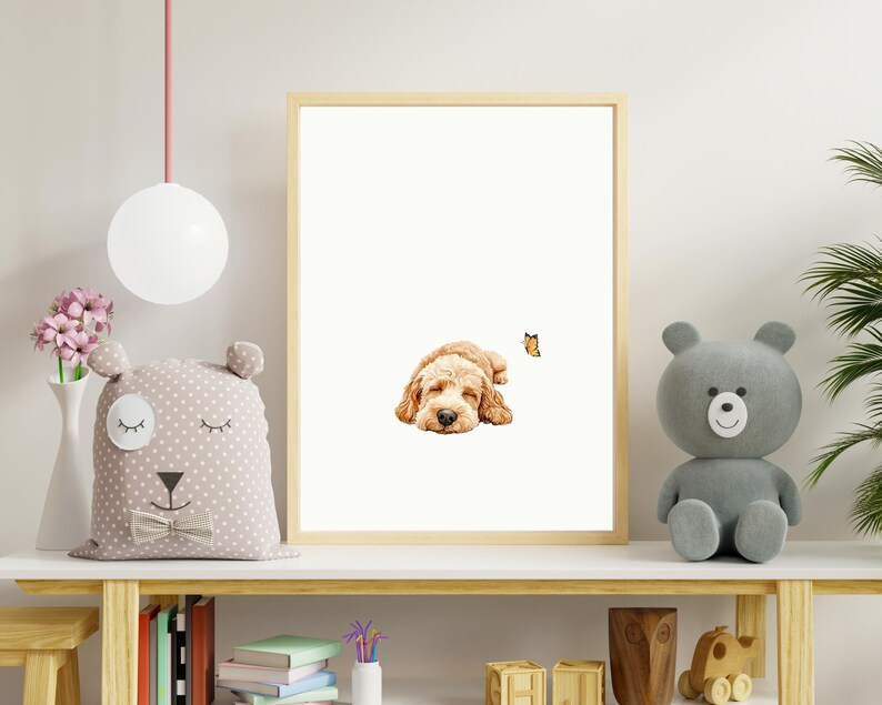 May include: A framed print of a golden doodle dog sleeping with a butterfly flying above it. The print is on a shelf with a stuffed animal bear, books, and other decorative items.