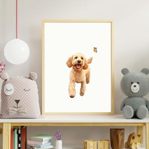 May include: A framed print of a golden doodle dog running towards a butterfly. The dog is smiling and has a white background.