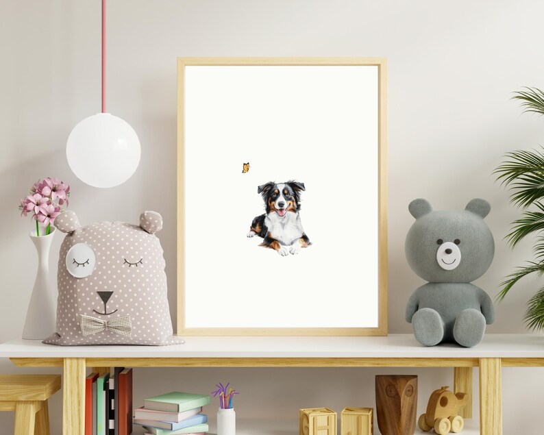May include: A framed watercolor painting of a black and white Australian Shepherd dog with a butterfly flying above it. The dog is sitting on a white background.