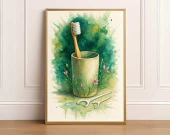 May include: Watercolor art print of a toothbrush in a ceramic cup, with dental floss picks, and floral accents. The background features green and yellow watercolor splashes. The artwork is framed in a gold-colored frame.