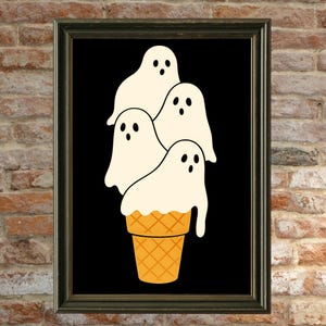 May include: A framed art print featuring a whimsical illustration of four white ghost figures stacked on top of a waffle cone. The ghosts have black eyes and the cone is orange. The background is black.