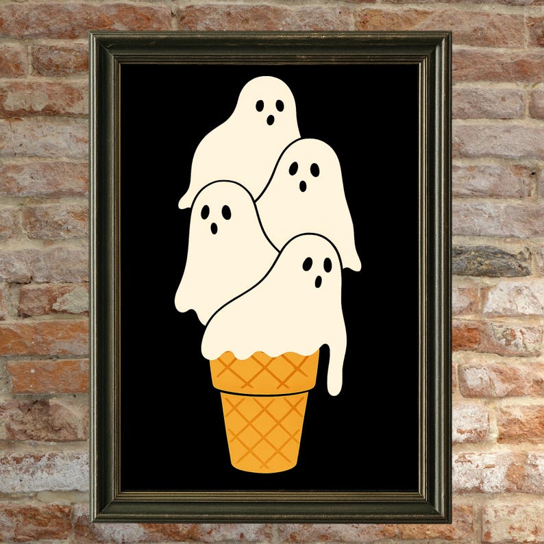 May include: A framed art print featuring a whimsical illustration of four white ghost figures stacked on top of a waffle cone. The ghosts have black eyes and the cone is orange. The background is black.