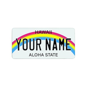 May include: A personalized Hawaii license plate with the text "YOUR NAME" in bold black letters. The plate features a rainbow arch design in pink, yellow, and blue, with "HAWAII" at the top and "ALOHA STATE" at the bottom.