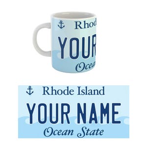 May include: White ceramic mug with a blue and white design. The mug features a blue anchor, the text "Rhode Island", "YOUR NAME", and "Ocean State".