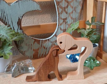 Handcrafted Wooden Figurine of a Man Bending Over Kissing His Dog