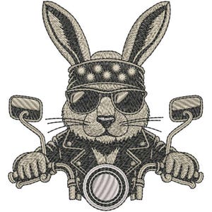 May include: Embroidered image of a rabbit wearing sunglasses, a bandana, and a leather jacket, riding a motorcycle. The rabbit's ears are upright, and it's holding the handlebars. The design is in shades of tan, black, and gray.