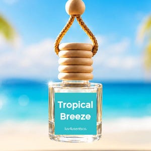 May include: A clear glass car air freshener bottle with a wooden cap and a braided tan cord for hanging. The bottle features a square turquoise label with the white text Tropical Breeze and the smaller text luv4usentsco. centered on the front.