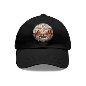 May include: Black baseball cap featuring a circular patch with a desert landscape and a rider on horseback. The patch includes the text "El Paso Texas" in a vintage style. The cap has a curved brim and an adjustable strap.