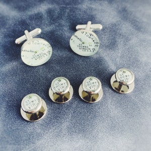 May include: Set of six silver cufflinks and studs with a white background and black text. The cufflinks and studs feature a star and the text "St. Thomas Virgin Is."