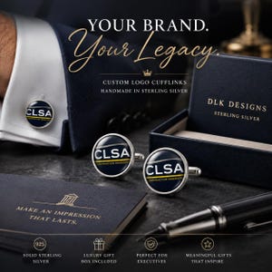 May include: Round sterling silver cufflinks featuring the CLSA Construction Managers logo in navy blue, white, and gold. The set includes a dark blue presentation box with the text DLK DESIGNS STERLING SILVER and a card reading MAKE AN IMPRESSION THAT LASTS.