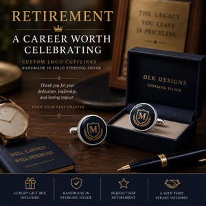May include: Round sterling silver cufflinks featuring a dark blue center with a gold-colored letter M inside a shield and laurel wreath design. The set includes a dark blue presentation box with the text DLK DESIGNS STERLING SILVER printed inside.