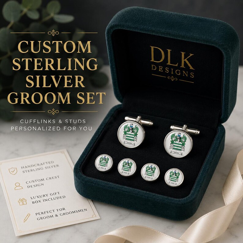 May include: A set of sterling silver cufflinks and studs featuring a custom crest design, presented in a dark green velvet box. The set includes two circular cufflinks and four matching studs, each displaying a detailed green and white heraldic emblem.
