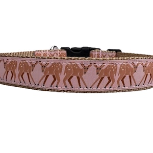 May include: A pink dog collar with a brown deer pattern. The collar is made from durable nylon and has a metal buckle.