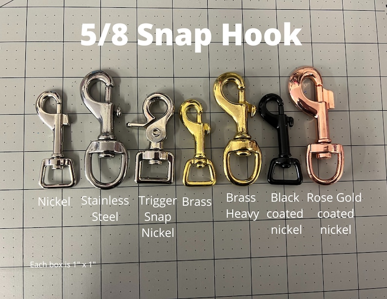 May include: A close-up of 5/8 inch snap hooks in various finishes: nickel, stainless steel, trigger snap nickel, brass heavy, black coated nickel, and rose gold coated nickel.