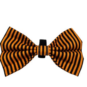 May include: A black and orange striped bow tie. The bow tie is made of fabric and has a black adjustable strap.