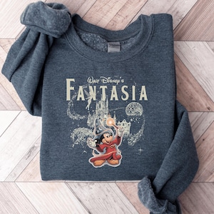 A gray sweatshirt with a Disney-themed graphic and text, including the character Mickey Mouse and the title "Fantasia".