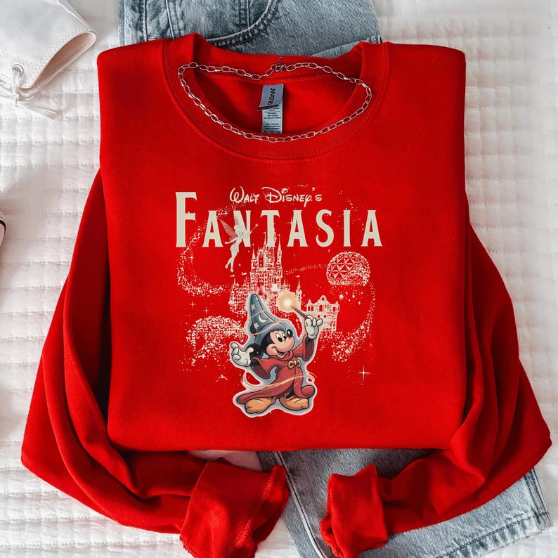 A red sweater with a Disney character and the text "Disney's Fantaasia" printed on it, along with a chain around the neck.