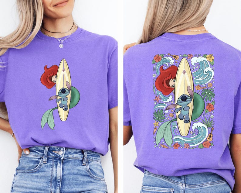 a woman wearing a purple t-shirt with a graphic design featuring a mermaid and a surfboard.
