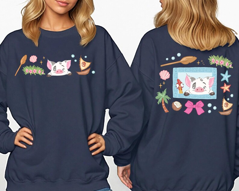 two women wearing navy blue sweatshirts with colorful cartoon pig designs and various decorative elements.