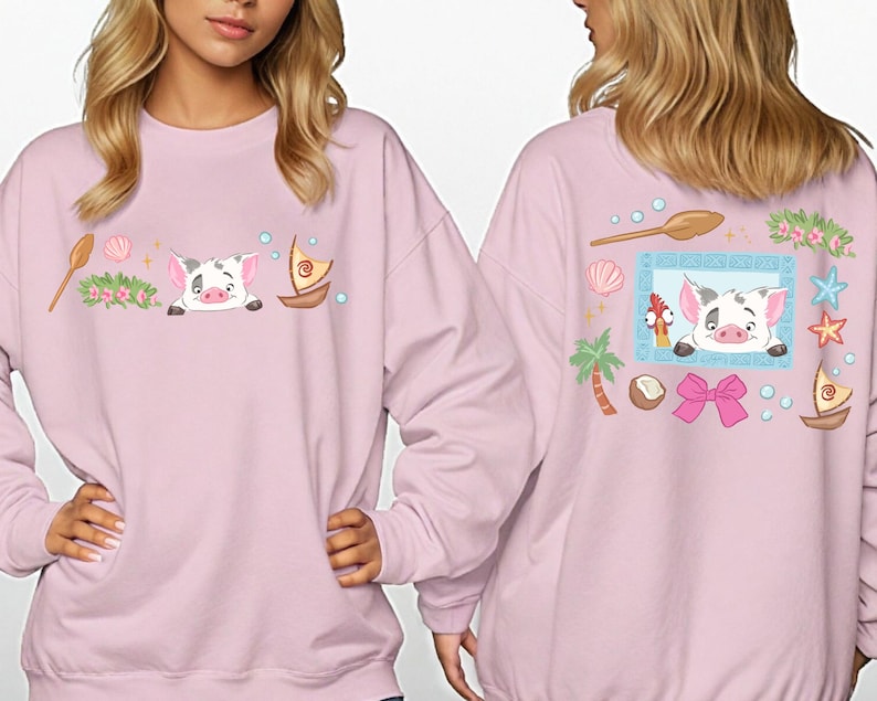 two women wearing pink sweatshirts with cartoon pig designs and various decorative elements.