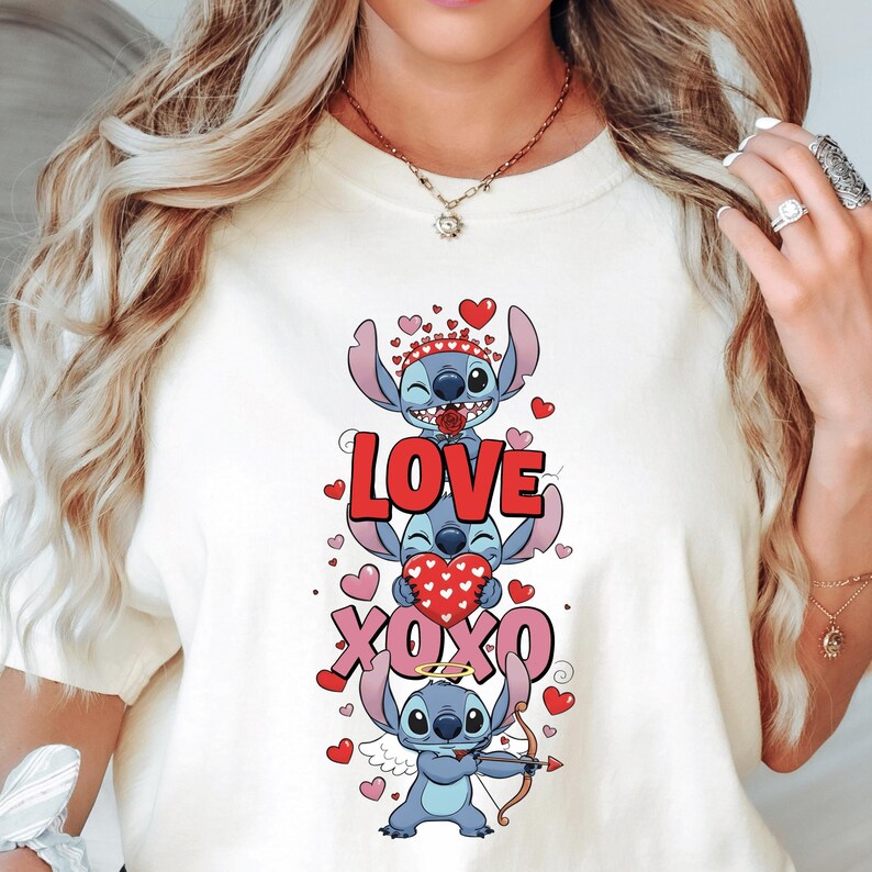 A woman wearing a white t-shirt with a graphic design featuring a cartoon character and the text "LOVE XOXO".
