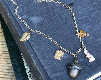 SALE. Woodland themed charm necklace. Rabbit, squirrel, leaves, acorn on gold tone chain