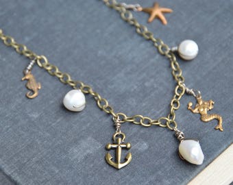 SALE. By the Sea. Brass and freshwater pearl ocean themed charm necklace