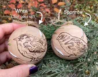 Handmade woodburned and painted bird ornaments. Choice of two birds, a wren or sparrow. Wood Christmas ball ornaments