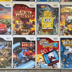 May include: A collection of Wii video game cases. Titles include "Cars: Race-O-Rama", "Looney Tunes: Acme Arsenal", "SpongeBob SquarePants: Atlantis SquarePantis", and "Destroy All Humans!"