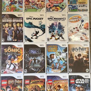 May include: A collection of Wii video game cases, featuring titles like "Super Paper Mario," "Epic Mickey," and "Lego Star Wars III." The game covers display colorful graphics and game titles.