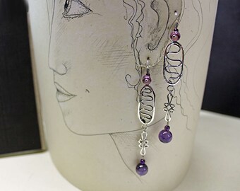 Sterling and Amethyst Earrings... Art of pliers, torch, and inspiration.  Handcrafted and designed in our studio.