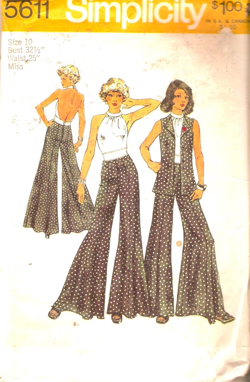 May include: A vintage Simplicity sewing pattern for a women's pantsuit. The pattern shows three women wearing different variations of the pantsuit, all with wide-legged trousers and a polka dot print. The pattern number is 5611 and the size is 10, with a bust of 32 1/2 inches and a waist of 25 inches.