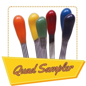 May include: A set of six paint sampler sticks with different colored paint tips. The colors are orange, yellow, green, red, blue, and black. The sticks are labeled "Quad Sampler".