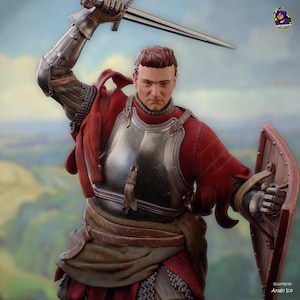 May include: A detailed figurine of a medieval knight in full armour, holding a sword aloft and a shield. The knight wears a red tunic and a metal breastplate. The background shows a blurred landscape. Sculpted by Arago Ice.