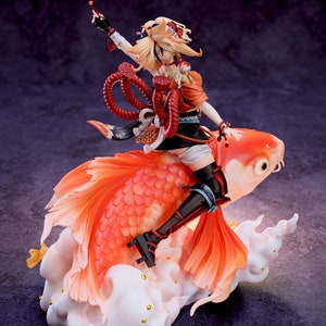 May include: A figurine of a character from the video game Genshin Impact, riding a large orange and red fish. The character is wearing a red and white outfit with a long, flowing blonde ponytail. The fish is on a white cloud base with gold accents. The figurine is made by Chuya Factory.