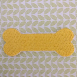 May include: A yellow felt bone-shaped toy.