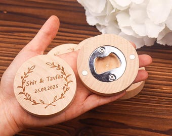 May include: Two wooden bottle openers with engraved text. One opener has the text "Shir & Tzvika 25.09.2025" and the other has a bottle opener.