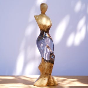 The woman sculpture by wood and resin