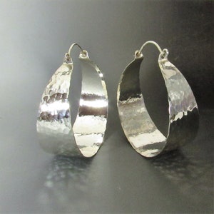 Dazzling mirror shiny hammered finish, extra large  argentium sterling silver hoop earrings. apx. 1300 hammer strikes give this pair wonderful finish, polished to a brilliance. The pair you wear when you need some serious ZING 2.25 inch x 2 wide.