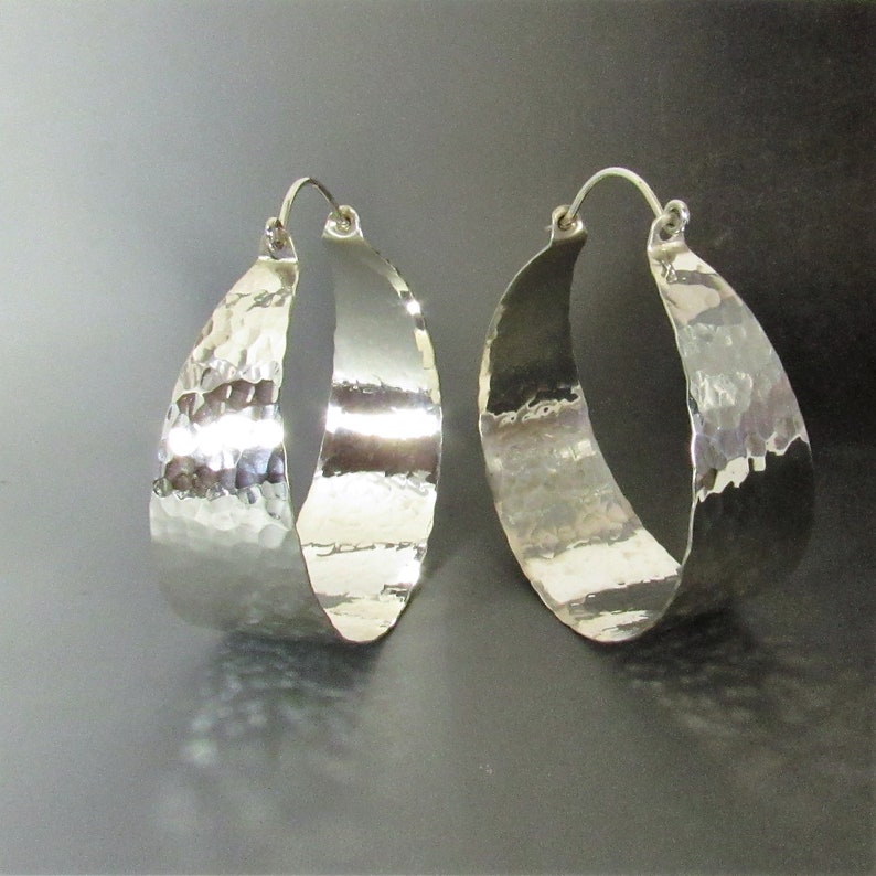 Dazzling mirror shiny hammered finish, extra large  argentium sterling silver hoop earrings. apx. 1300 hammer strikes give this pair wonderful finish, polished to a brilliance. The pair you wear when you need some serious ZING 2.25 inch x 2 wide.