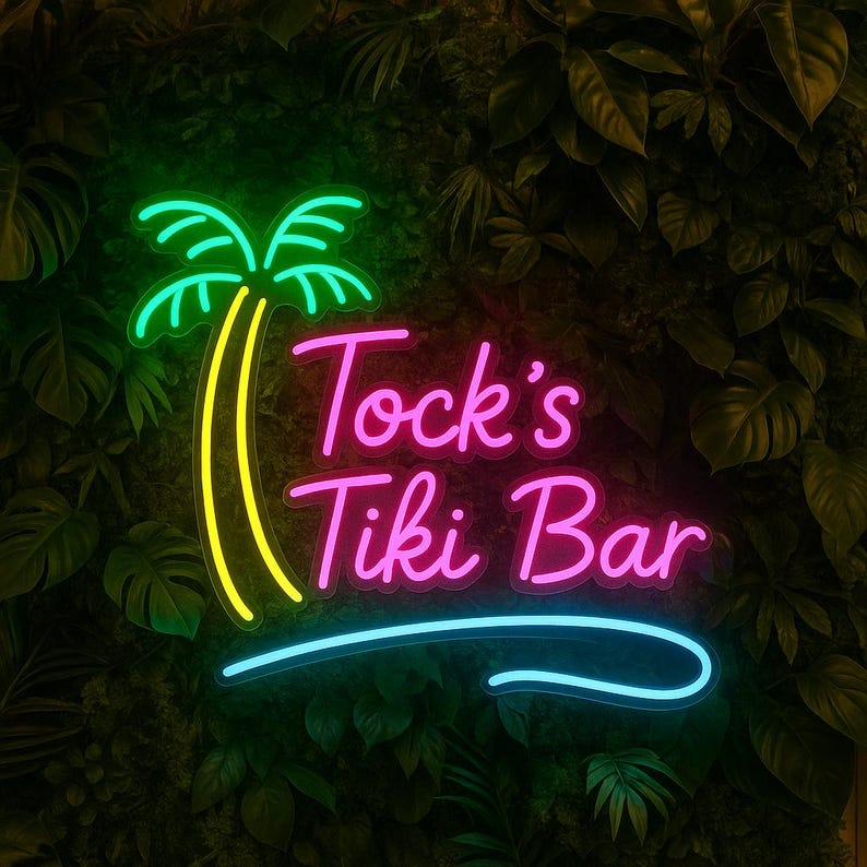 May include: A neon sign for "Tock's Tiki Bar" with a palm tree graphic. The sign features bright green, yellow, pink, and blue colors. The sign is set against a backdrop of lush green foliage.