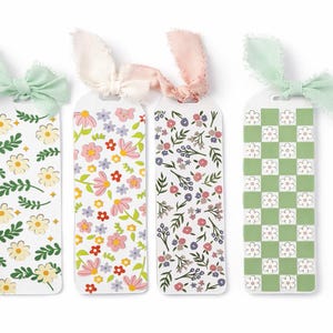May include: Four floral-themed bookmarks with decorative ribbons. Each bookmark features a different design: daisies and leaves, pink and red flowers, a mix of purple and pink flowers, and a green and white checkerboard pattern with flowers.