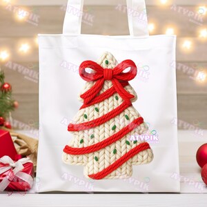 May include: White tote bag featuring a Christmas tree design. The tree is cream-colored with red accents, including a bow at the top and a decorative border. Green dots are scattered across the tree, adding a festive touch.
