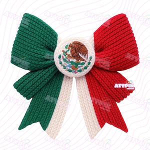 May include: A large, knitted bow in the colours of the Mexican flag: green, white, and red. The bow features a central circular emblem with the Mexican coat of arms. The bow's design is symmetrical, with the green and red sections mirroring each other.