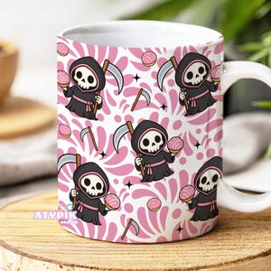 May include: White ceramic mug with a repeating pattern of a cartoon Grim Reaper holding a pastry and a scythe, set against a pink and white background. The mug has a white handle and the text "ATYPIK DESIGNS" is visible.