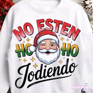 May include: White sweatshirt with a Santa Claus graphic. The design includes the words "NO ESTEN HO HO HO JODIENDO" in red, green, and black. Santa is winking and wearing a red hat.