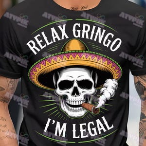 May include: Black t-shirt with a graphic of a skull wearing a sombrero and smoking a cigar. The text "RELAX GRINGO I'M LEGAL" is printed above and below the skull in white.