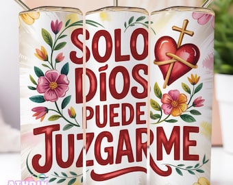 May include: A white tumbler with a floral design and the text "SOLO DIOS PUEDE JUZGARME" in red. The tumbler features a heart with a cross and colorful flowers. Includes a gold-colored straw.