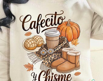May include: Beige sweatshirt with a fall-themed graphic. The design includes a coffee cup, pumpkin, bread, scarf, and boots. Text reads "Cafecito y Chisme". The design has a cozy, autumn aesthetic.