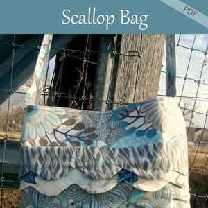 May include: A handmade Scallop Bag with a floral pattern in shades of blue, gray, and white. The bag features a scalloped edge design and a matching strap. The text "Scallop Bag" is at the top, and "Patchwork Posse" is at the bottom.